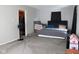 Large bedroom with a walk-in closet, black bed, and a ceiling fan at 219 N 9Th Ave, Beech Grove, IN 46107