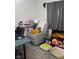 Bedroom showcasing a recliner, desk, and shelving unit with various accessories at 219 N 9Th Ave, Beech Grove, IN 46107