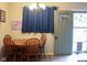 Bright dining area showcasing a wooden table with seating, a chandelier, and a view to the exterior at 219 N 9Th Ave, Beech Grove, IN 46107