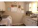 Well-lit kitchen featuring modern countertops, sink, and white cabinetry for a clean, organized space at 219 N 9Th Ave, Beech Grove, IN 46107