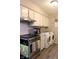 Efficient kitchen equipped with stainless steel appliances, an oven, and a nearby washer and dryer at 219 N 9Th Ave, Beech Grove, IN 46107