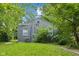 The backyard has a well kept lawn and a home featuring grey siding at 2359 N Gale St, Indianapolis, IN 46218