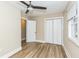 Bedroom featuring wood-look floors, closet, and adjacent room at 2359 N Gale St, Indianapolis, IN 46218