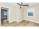 Bright bedroom with wood-look floors and a large window at 2359 N Gale St, Indianapolis, IN 46218