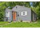 Charming home featuring grey siding, an orange front door, well-kept lawn and an inviting curb appeal at 2359 N Gale St, Indianapolis, IN 46218