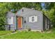 Charming home featuring grey siding, an orange front door, well-kept lawn and an inviting curb appeal at 2359 N Gale St, Indianapolis, IN 46218