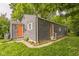 Charming home featuring grey siding, an orange front door, and well-kept lawn and an inviting curb appeal at 2359 N Gale St, Indianapolis, IN 46218