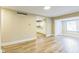 Spacious living room with wood-look vinyl flooring leading to kitchen area with white cabinets and appliances at 2359 N Gale St, Indianapolis, IN 46218