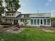Spacious backyard with patio, upper deck, fire pit, and lush greenery at 251 North St, Danville, IN 46122