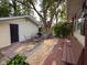 Backyard with an outdoor dining area, grill, shed, and mature trees offering shade at 251 North St, Danville, IN 46122