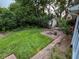 Lush backyard with brick-lined fire pit, garden shed, and well-maintained lawn at 251 North St, Danville, IN 46122