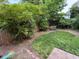 Serene backyard featuring mature trees, garden bench, and a peaceful setting at 251 North St, Danville, IN 46122