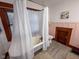 Bright bathroom featuring a classic clawfoot tub, natural light, and vintage-inspired fixtures at 251 North St, Danville, IN 46122