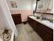 Bright bathroom featuring double sinks, granite counters, decorative vanity, and a classic clawfoot tub with shower at 251 North St, Danville, IN 46122
