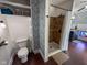 Functional bathroom featuring a tiled shower, toilet, and well-organized storage shelves at 251 North St, Danville, IN 46122