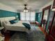 Comfortable bedroom with blue accent wall, ceiling fan, and ample natural light at 251 North St, Danville, IN 46122