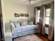 Inviting bedroom featuring a daybed, neutral decor, and natural light from the windows at 251 North St, Danville, IN 46122