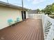 Large outdoor deck with light brown floor boards, white lattice railing, and brightly colored outdoor chairs at 251 North St, Danville, IN 46122