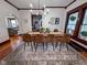 The Dining room has a dark wood table, seating for six, hardwood floors, and lots of natural light at 251 North St, Danville, IN 46122