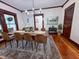 The Dining room features a dark wood table with seating for eight, hardwood floors, and lots of natural light at 251 North St, Danville, IN 46122