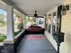 Relaxing front porch with swing, ceiling fan, and a view of the neighborhood at 251 North St, Danville, IN 46122