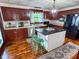 The Kitchen features dark cabinets, stainless steel appliances, an island, and a decorative tin ceiling at 251 North St, Danville, IN 46122