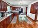 The Kitchen features an island, stainless steel appliances, and decorative tin ceiling at 251 North St, Danville, IN 46122