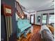 Bright living room boasts a vintage piano, hardwood floors, and lots of natural light from large windows at 251 North St, Danville, IN 46122