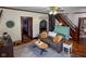 Comfortable living room with a couch, a piano, hardwood floors, and an archway leading to another room at 251 North St, Danville, IN 46122