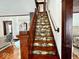 Beautiful staircase with detailed wood trim and floral patterned stair coverings at 251 North St, Danville, IN 46122