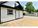 This backyard has a fresh wood deck, newly painted siding, and a gravel driveway at 2801 E Southport Rd, Indianapolis, IN 46227