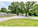 Spacious backyard with gravel area, shed, and mature trees offering ample outdoor space at 2801 E Southport Rd, Indianapolis, IN 46227