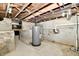 The basement features block foundation, exposed plumbing and modern hot water tank at 2801 E Southport Rd, Indianapolis, IN 46227