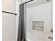 Bathroom with subway tile surround, tiled niche and shower curtain at 2801 E Southport Rd, Indianapolis, IN 46227