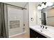 Modern bathroom with a dark vanity, white sink, and a tiled shower/tub combo at 2801 E Southport Rd, Indianapolis, IN 46227