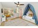 The bedroom showcases a cozy daybed with a blue canopy and a nearby bunk bed set, offering a playful retreat at 2801 E Southport Rd, Indianapolis, IN 46227