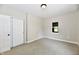 Bright bedroom featuring neutral walls, soft carpeting, a closet, and a window at 2801 E Southport Rd, Indianapolis, IN 46227