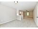 Open, carpeted loft area featuring a fan and sunny bedroom at 2801 E Southport Rd, Indianapolis, IN 46227