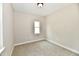 Bright, carpeted bedroom with modern trim and a sunlit window at 2801 E Southport Rd, Indianapolis, IN 46227
