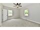 Bedroom features plush carpet, ceiling fan and windows offering natural light at 2801 E Southport Rd, Indianapolis, IN 46227