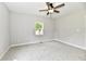 Bedroom featuring soft carpet, light gray walls, ceiling fan, and a sunlit window at 2801 E Southport Rd, Indianapolis, IN 46227