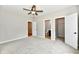 Bedroom with carpet and neutral colors featuring a ceiling fan and walk-in closet at 2801 E Southport Rd, Indianapolis, IN 46227