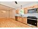 Bright kitchen with stainless steel appliances, light wood cabinets and grey countertops at 2801 E Southport Rd, Indianapolis, IN 46227