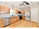 Kitchen with wood cabinets, granite counters, stainless steel appliances, and a modern refrigerator at 2801 E Southport Rd, Indianapolis, IN 46227