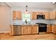 Kitchen with wood cabinets, granite counters, stainless steel appliances, and a large window at 2801 E Southport Rd, Indianapolis, IN 46227