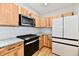 Newly renovated kitchen with light wood cabinets, stainless appliances and modern lighting at 2801 E Southport Rd, Indianapolis, IN 46227