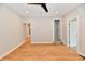 The spacious living room has light wood floors, neutral colored walls and modern fan at 2801 E Southport Rd, Indianapolis, IN 46227