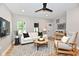This living room is bright and airy, with modern furniture, a ceiling fan, and a neutral color palette at 2801 E Southport Rd, Indianapolis, IN 46227