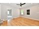 Light and airy living room features light wood floors, neutral colored walls and modern fan at 2801 E Southport Rd, Indianapolis, IN 46227