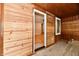 The living room boasts light-colored wood walls, a neutral floor, and large windows at 2801 E Southport Rd, Indianapolis, IN 46227